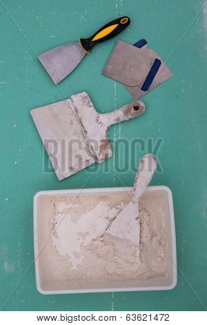 Platering tools for plaster like plaste trowel spatula on green drywall plasterboard
