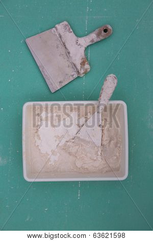 Platering tools for plaster like plaste trowel spatula on green drywall plasterboard
