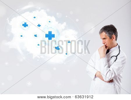 Proffesional doctor listening to abstract cloud with medical signs
