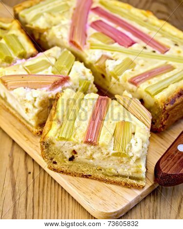 Pie with curd and rhubarb on board