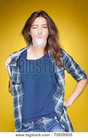 young beautiful girl posing grimacing with chewing gum