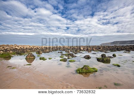 Beach With Rocks In The Sand At Cayton Bay, Uk
