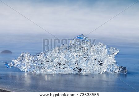 Jokulsarlon Ice in morning sun lights on sea beach