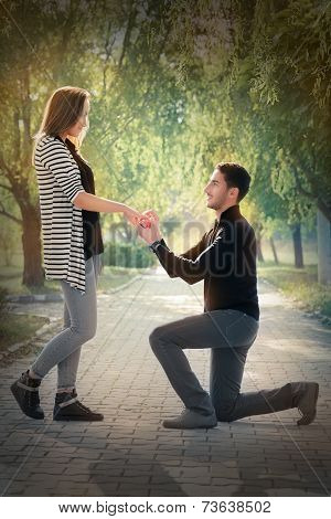 Kneeling Man Proposing with an Engagement Ring