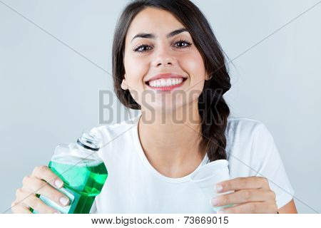 Beautiful Girl Using Mouthwash. Isolated On White.