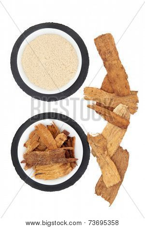 Astragalus herb and powder used in chinese herbal medicine over white background.
