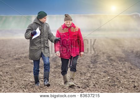 Farmers On Plowed Field