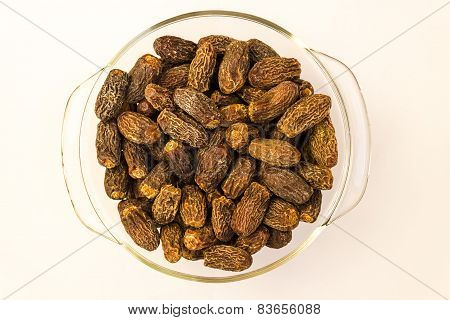 closeup view of Dry Medjool variety Dates fruit arranged in a glass bowl