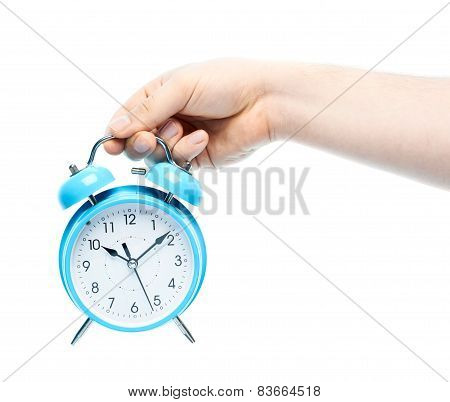 Caucasian male hand holding alarm clock