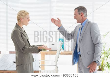 Furious boss yelling at colleague in an office