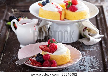 Pasrtry cups filled with cream and fresh berries