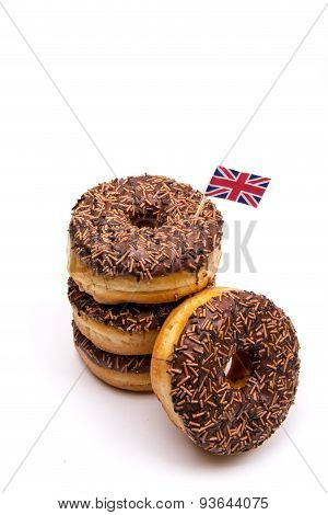 A stack of Chocolate donuts with a British Flag