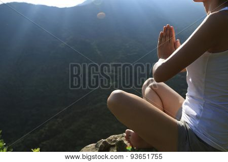 young yoga woman at sunrise mountain peak