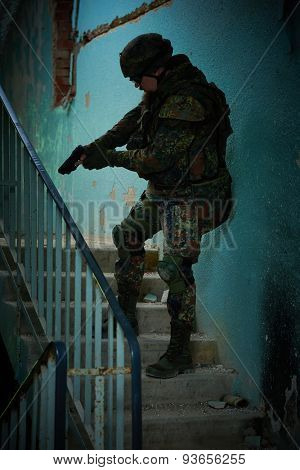 military. soldier with pistol in nato germany uniform with pistol indoord