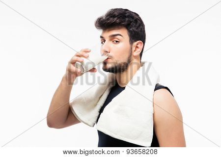 Handsome man drinking milk isolated on a white background. Looking at camera