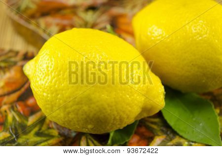 Two Lemons On A Decorated Table