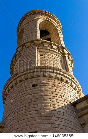 Minaret of the mosque in the background of blue sky