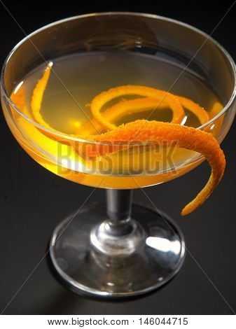 Satan Whiskers cocktail isolated on black background. Made from 1 oz gin 1/2 oz orange liqueur 1 oz dry vermouth 1 oz sweet vermouth 1 oz orange juice 2 dashes orange bitters