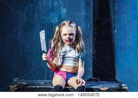 Bloody Halloween theme: The crazy girl with knife on dark