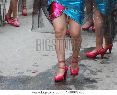 Cajamarca Peru - February 7 2016: Costumed woman's legs in bright pink shoes in Carnival parade in Cajamarca Peru on February 7 2016