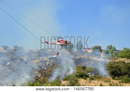 August 21 2016-Monti Prenestini-Castel San Peter- Roma-Lazio-Italy-the helicopter of the fire brigade to put out an arson attack on the slopes Prenestini who is skirting the first inhabited houses