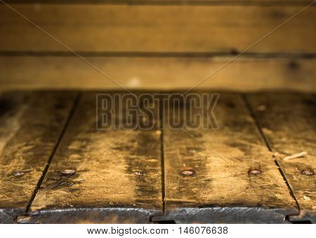 an old wood shelf and dark wall