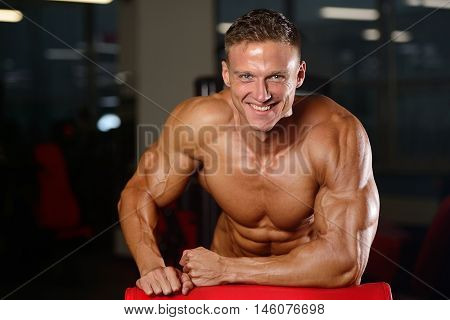 Handsome Muscular Bodybuilder Man Doing Exercises In Gym