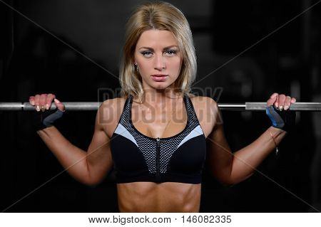 Beautiful Fitness Woman Trains In The Gym.