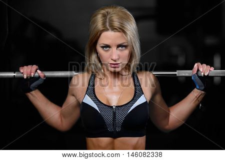 Beautiful Fitness Woman Trains In The Gym.