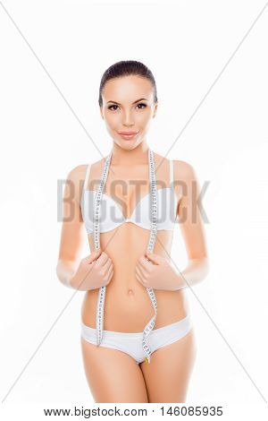 Portrait Of Young Slim Woman In White Underwear With Measuring Tape
