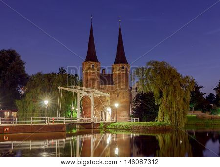 Eastern Gate with the white draw bridge, along Delftse Schie canal at night, Delft, Holland, Netherlands