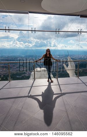 Woman in the El Santisimo statue of Jesus Christ with Bucaramanga in the background