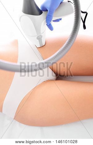 Woman on laser hair removal treatments thighs and bikini area