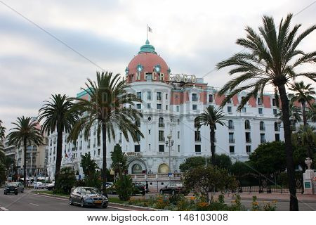 Cannes, France - July 3 2012. Beautiful orange building Hotel Negresco on the Mediterranean coast.