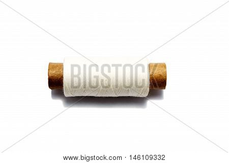 Spool of old white thread on white background. Isolated