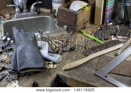 Various tools, hinges and other items in a bookbinders studio.