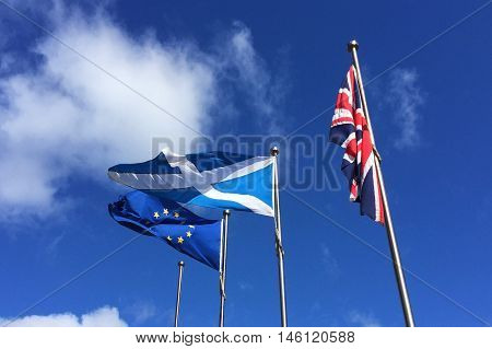 European Union EU and Scotland flags flying and drooping United Kindgom UK flag - Brexit , Independence
