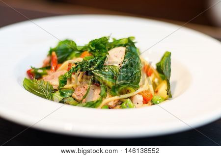 The spaghetti mixed with stir-fried spicy fish. Aromatic spices taste