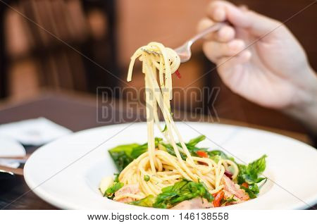 The spaghetti mixed with stir-fried spicy fish. Aromatic spices taste