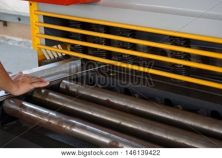 worker cut the stainless plate with the press cutting mechine