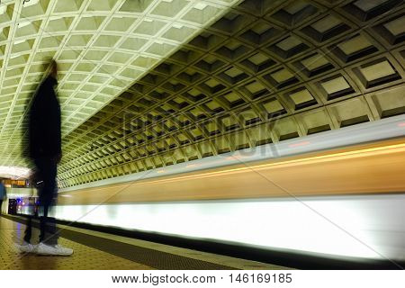 Washington D.C. - Subway station with passengers and train in motion blur

