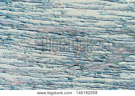 Old wooden wall with cracked and peeling green paint. Textured background.