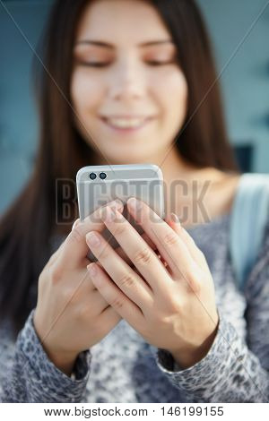 Smiling Young Girl Using Modern Dual Camera Smart Phone