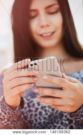 Young Pretty Model Using Modern Dual Camera Smart Phone