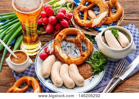 Traditional Bavarian meal. White sausages with sweet mustard and pretzel