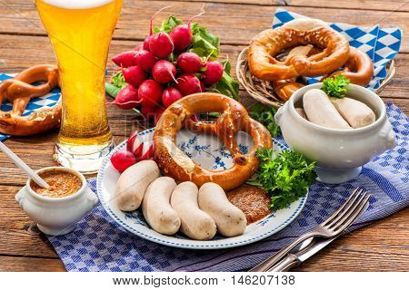 Traditional Bavarian meal. White sausages with sweet mustard and pretzel