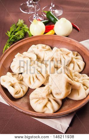 hot fresh georgian food,hinkali with parsley in restaurant