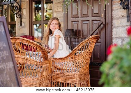 young woman in caffee looking aside. Fashion portrait