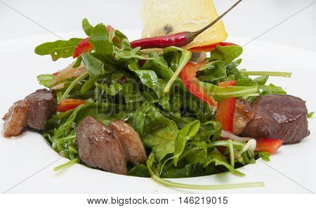 duck with arugula on a white background in the restaurant
