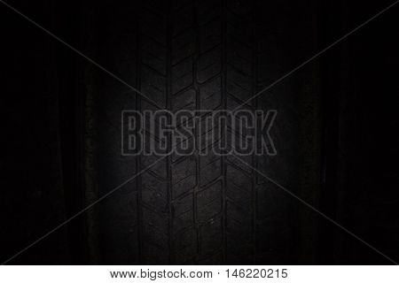Car tires in a row on a shelf tire. Close-up in dark.